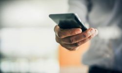 Close up of human hand holding smart phone. Business people.